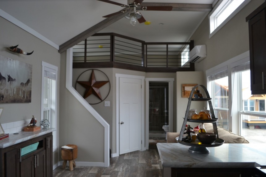 The Zircon tiny house boasts a fireplace on the porch and an XL kitchen