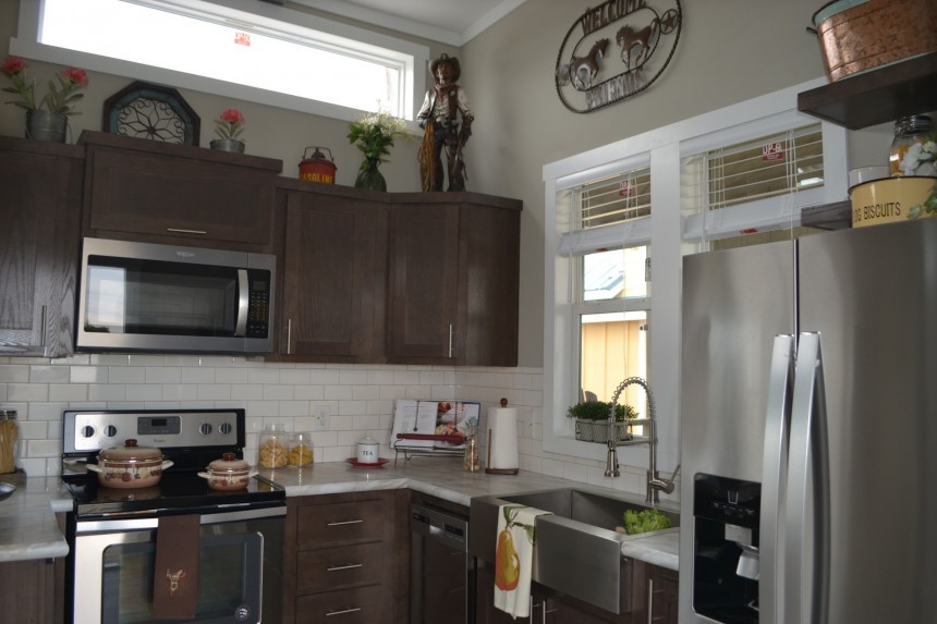 The Zircon tiny house boasts a fireplace on the porch and an XL kitchen